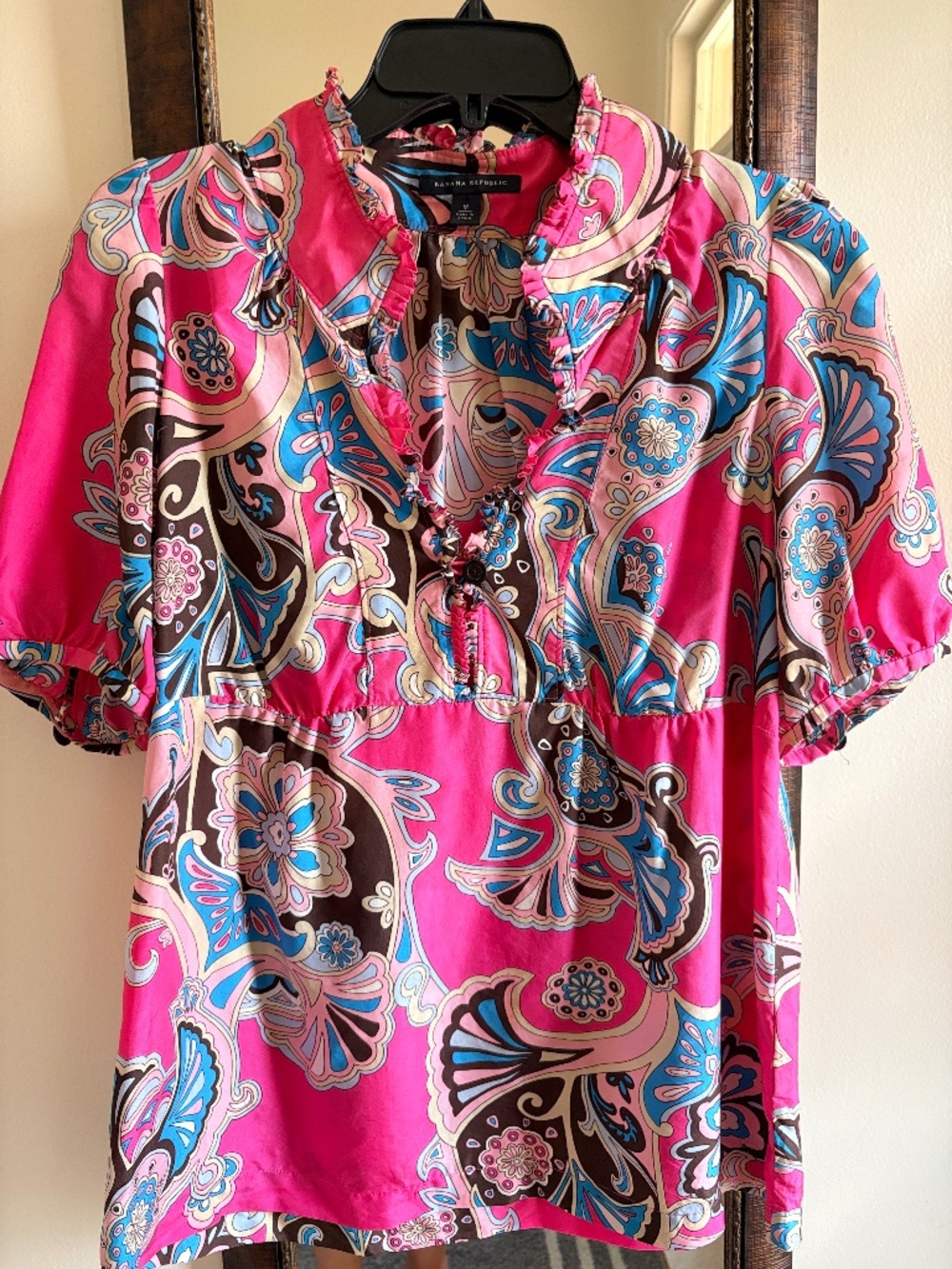 100% Silk ruffle-neck blouse.